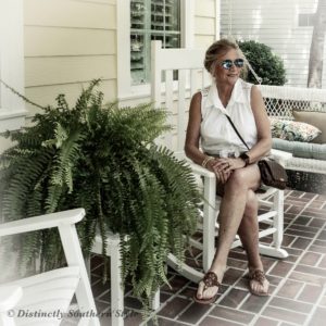 Woman sitting on the porch musing over September in the South