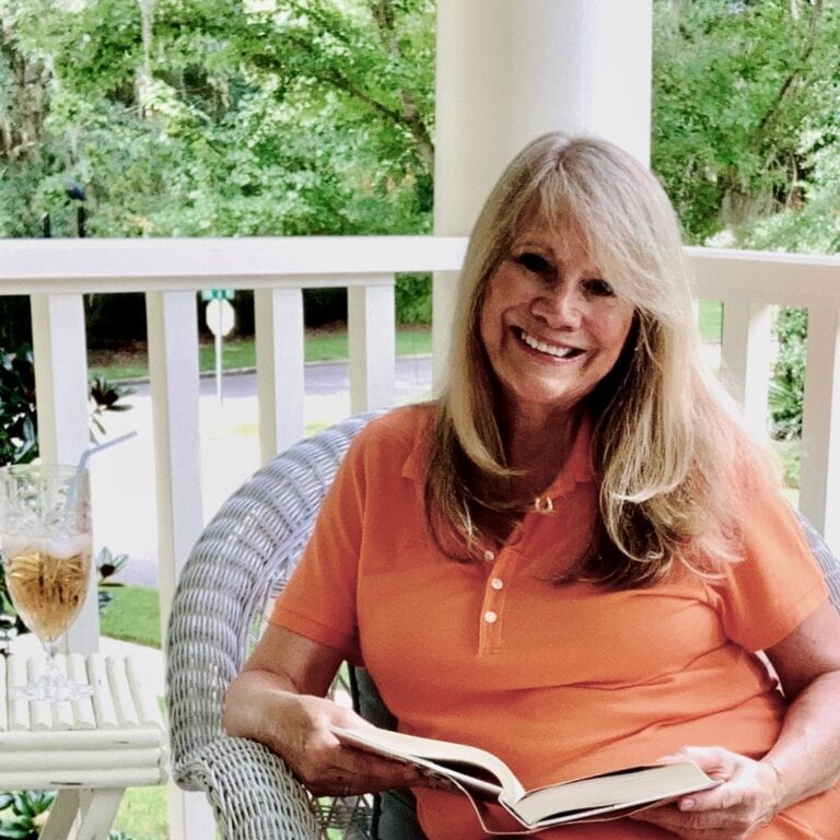 Woman reading and enjoying summer at home