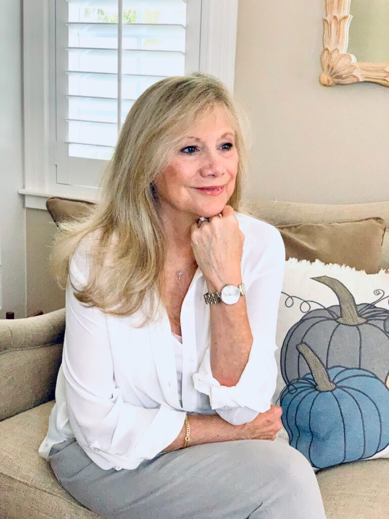 Woman wearing a rose gold timepiece.