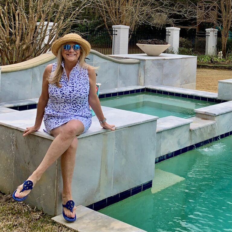 Woman sitting on the pool wearing an activewear dress