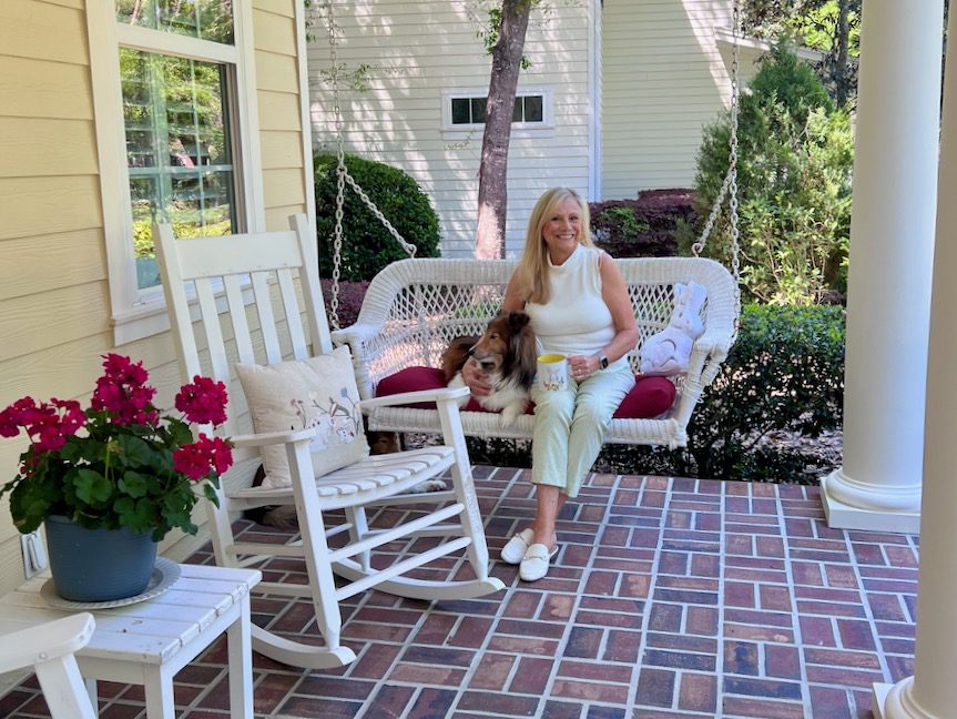 Woman and dog sitting on a swing - Hello April - Front Porch Coffee Chat