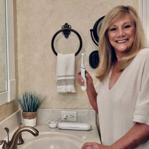 Woman holding an electric toothbrush. blog post 5 Amazon Prime Favorites