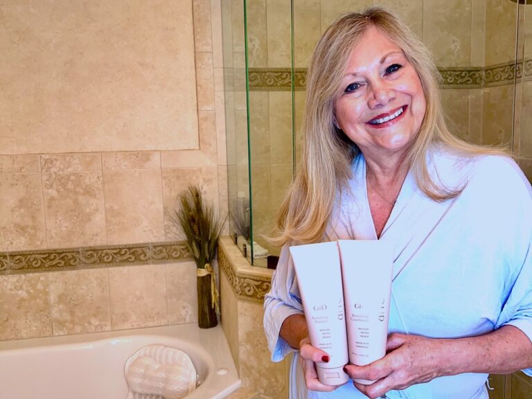 Woman holding Vegamour Shampoo and Conditioner