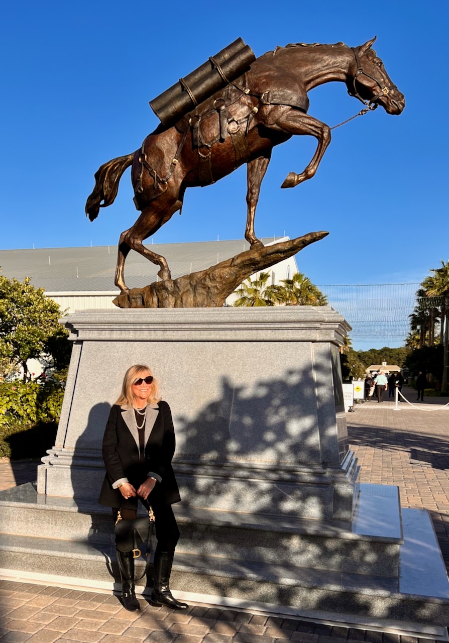 A woman standing in front of a horse statue at the World Equestrian Center in Ocala, Florida.