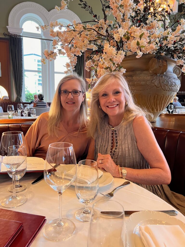 Two blonde women at a restaurant.