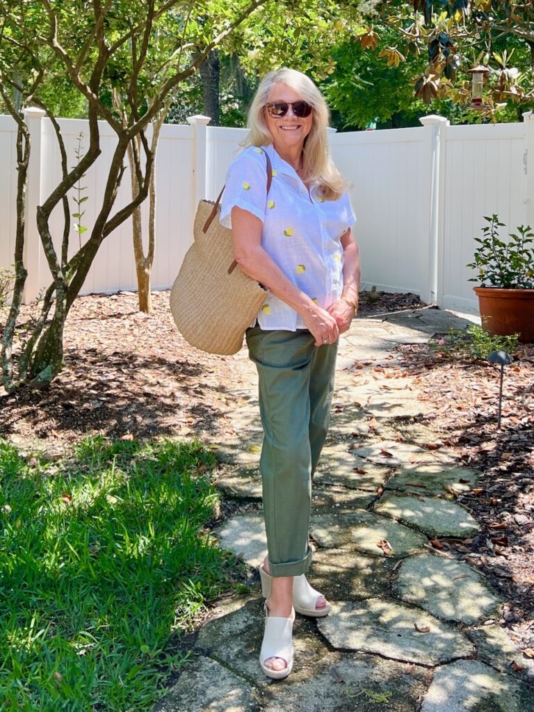 Favorite Straw Tote - A woman wearing a white shirt with embroidered lemon on it, green cuffed pants, and holding a favorite straw tote.