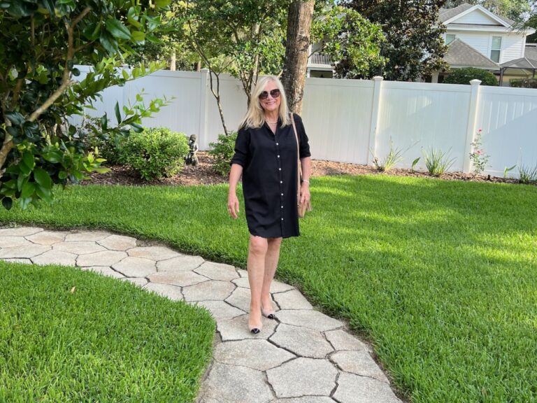 A woman on a stone path wears Ally Shoes and a black dress.