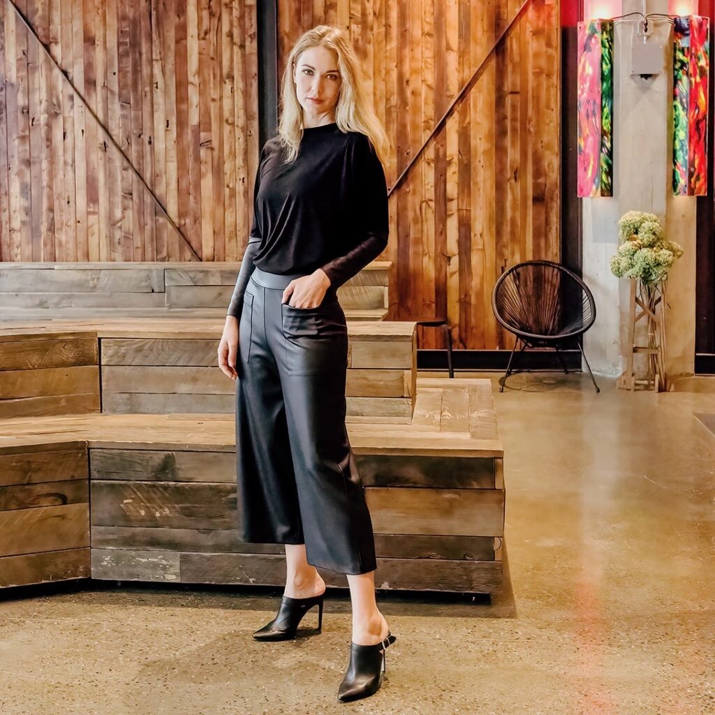 A model is wearing gaucho pants and a black sweater. 