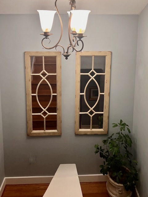 A pair of matching mirrors on a stairway landing.