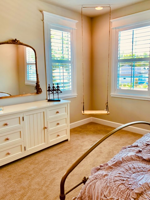 White dresser with a gold mirror above it.