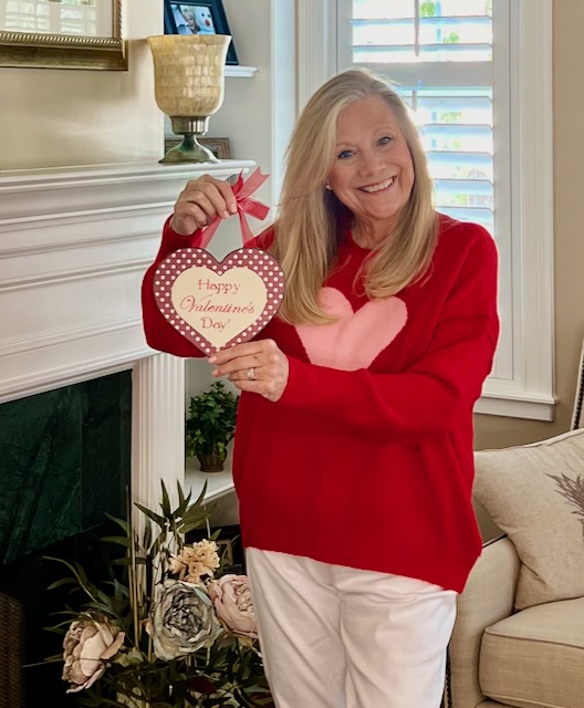 woman holding a Happy Valentine's Day heart